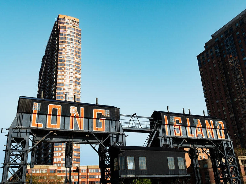 Long Island city sign with urban buildings in the backdrop