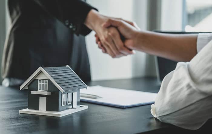 Handshake over house model to close Brentwood home deal