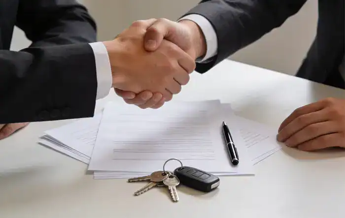 Professionals shaking hands over a home sale contract