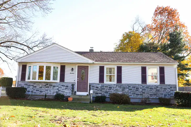 Ranch style Selden home with stone base and fall foliage
